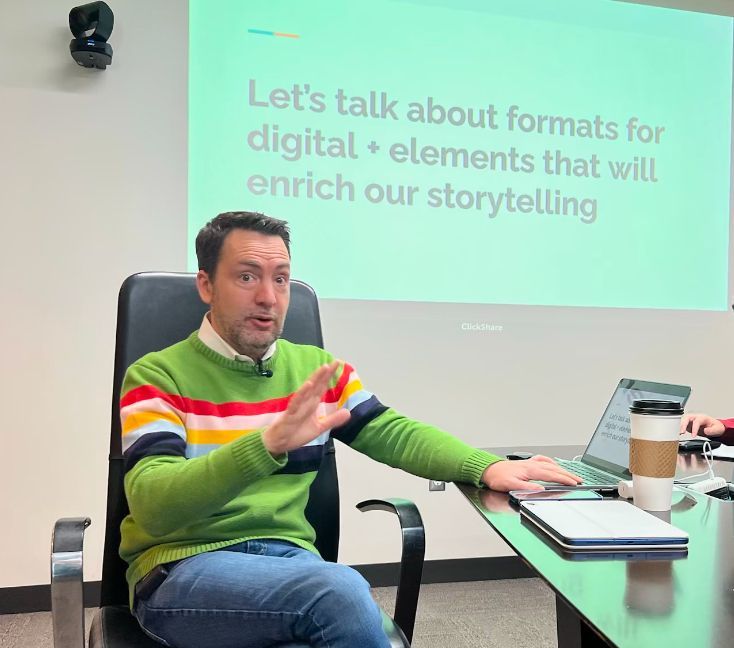 Image of David Arkin speaking to a company about digital elements enriching storytelling